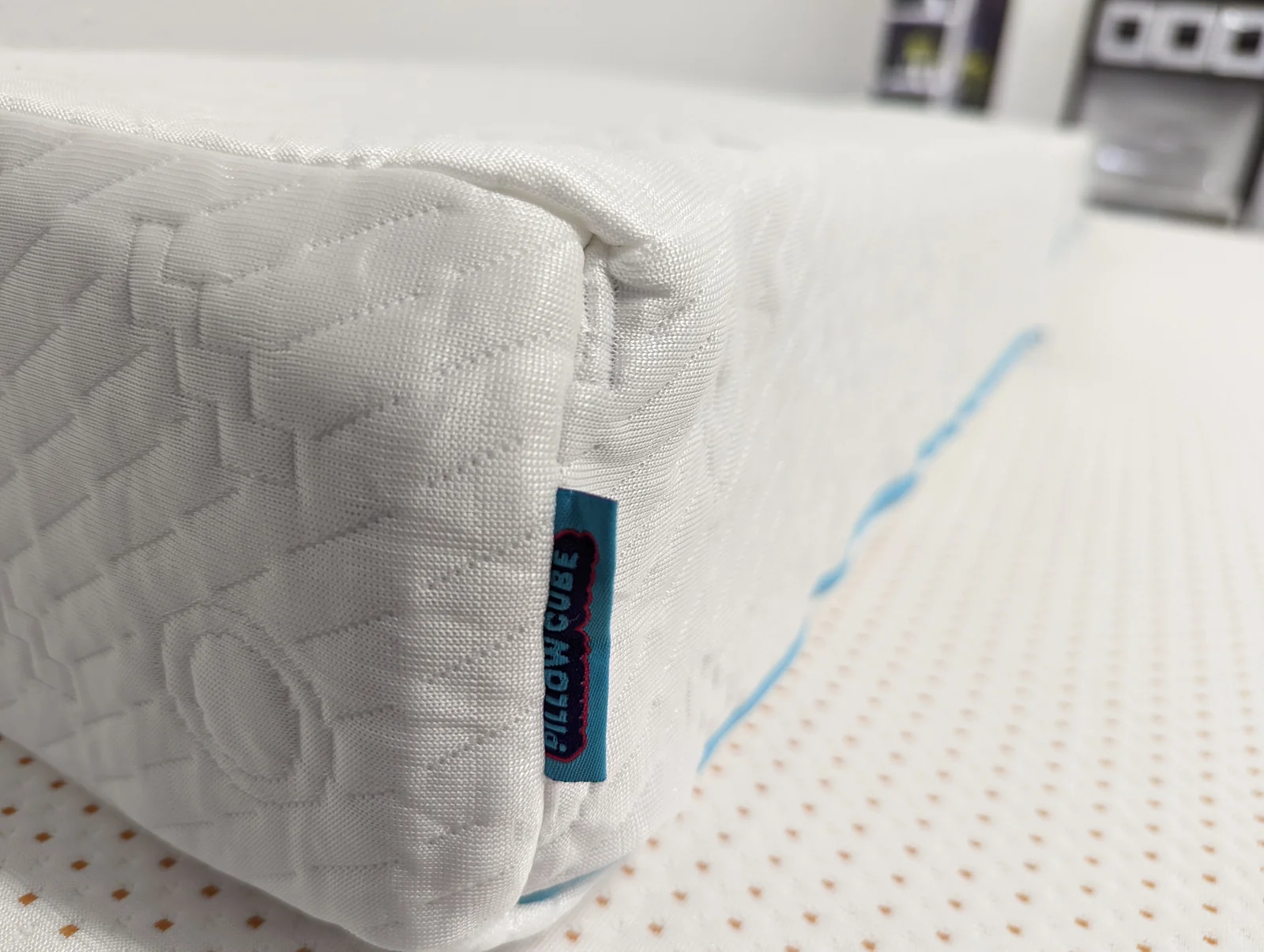 Close-up archival photograph of Pillow Cube Ice Cube stitching, fabric texture and sewn-in product label